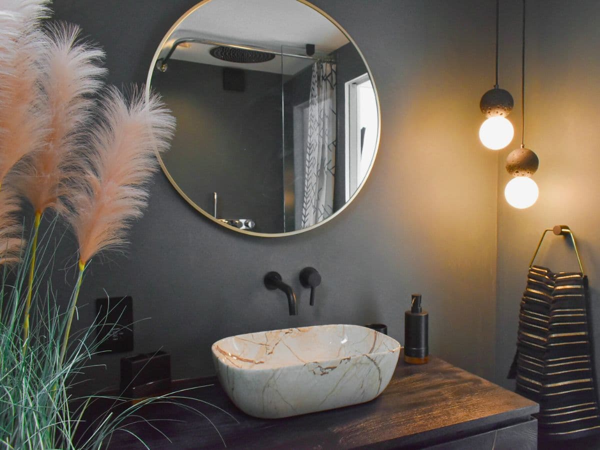 Pendant lighting installed above an ensuite basin in a Weybridge home